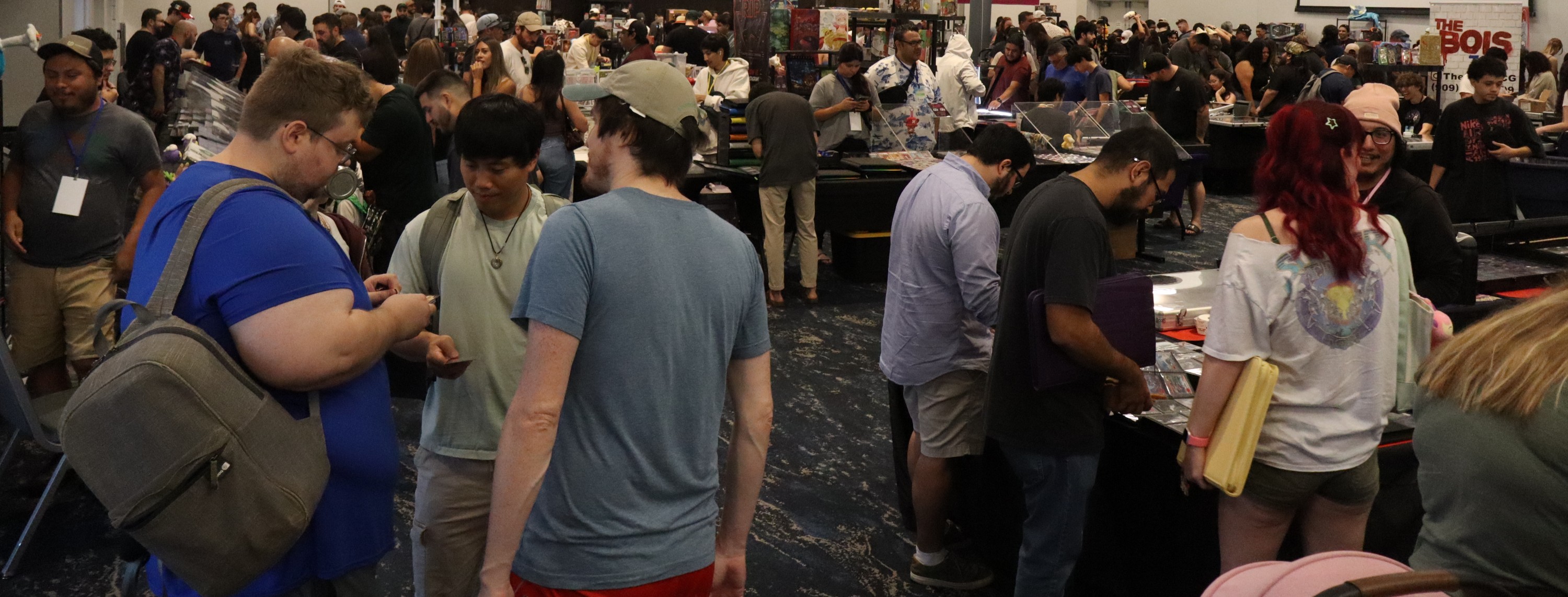 Vendor table with trading cards in display cases at the show